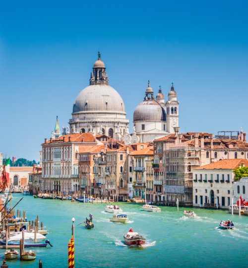 Beautiful view of famous Canal Grande with Basilica di Santa Maria della Salute in the background on a sunny day in summer, Venice, Italy.